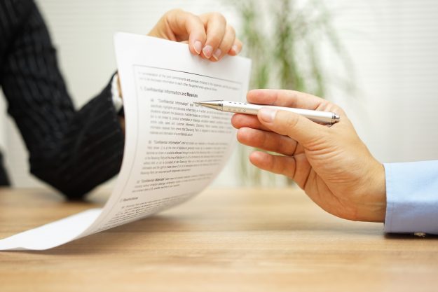 businesswoman holding legal document and  wants an explaination about article