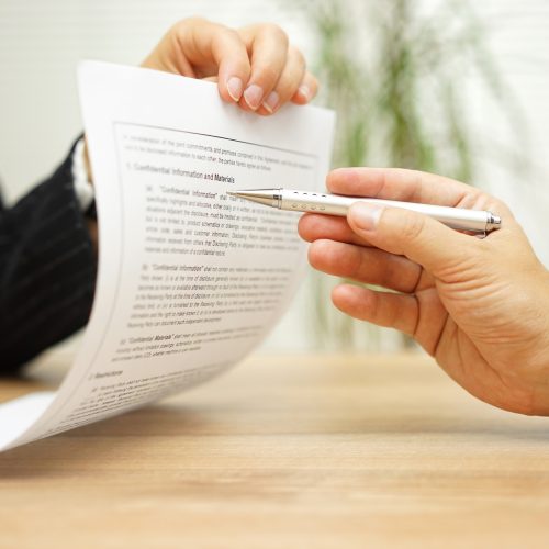 businesswoman holding legal document and  wants an explaination about article in contract